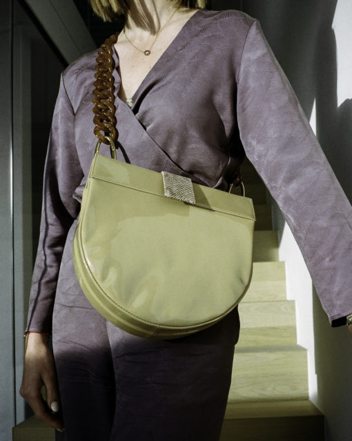 half-moon bag with patent leather and python print. plexiglass chain. perfect bag for everyday use. can hold an iPad, water bottle and more.