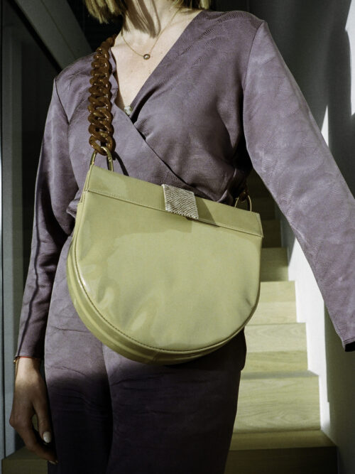 half-moon bag with patent leather and python print. plexiglass chain. perfect bag for everyday use. can hold an iPad, water bottle and more.   