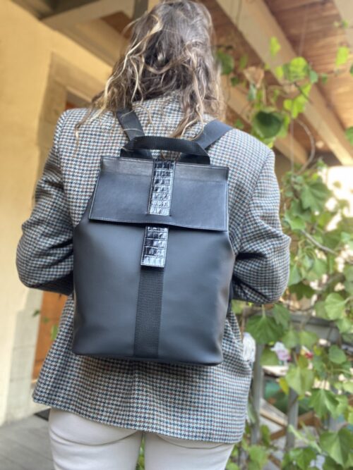 Waterproof backpack perfect for women cyclists for elegant, sporty style. Perfect for active women. Neoprene, smooth leather and black crocodile print. blue interior with plenty of storage space. handmade in geneva.    